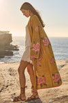 Woman in a floral kimono standing on a beach with ocean view
Coastal Granny Maxi Cardigan
