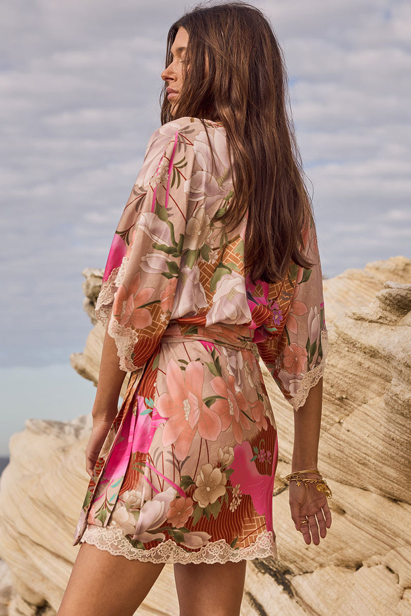 Woman wearing a floral dress standing on rocky cliffs with ocean view
Floridian Lace Mini Dress