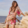 Woman in a floral dress standing on a rocky beach with ocean view
Floridian Lace Mini Dress