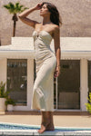 Woman in a strapless dress standing by a pool with palm trees in the background
Playa Midi Dress
