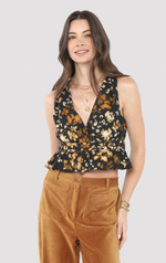 Woman wearing a floral top and brown pants on a light gray background
With Ease V Neck Peplum Top