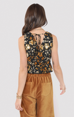 Woman wearing a floral sleeveless top and brown pants on a white background
With Ease V Neck Peplum Top