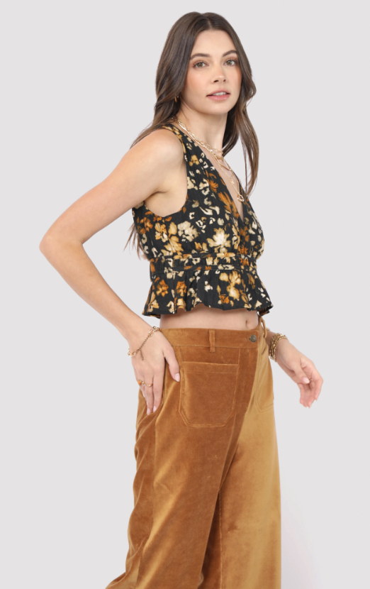 Woman wearing a floral top and brown pants on a light gray background
With Ease V Neck Peplum Top
