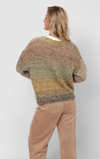 Woman wearing a multicoloured cardigan over a white shirt with beige pants on a plain background
Smiley Ombre Knit Cardigan