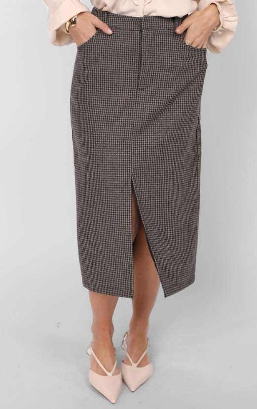 Woman wearing a light pink blouse with ruffled details and a gray houndstooth skirt on a white background
Outta Here Houndstooth Midi Skirt