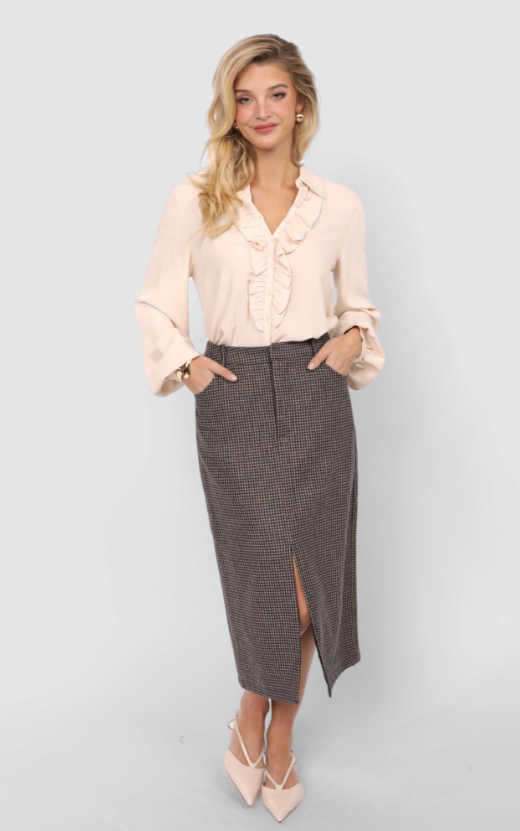 Woman wearing a light pink blouse with ruffled details and a gray houndstooth skirt on a white background
Outta Here Houndstooth Midi Skirt