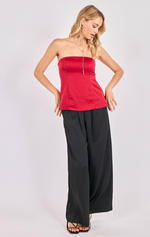 Woman wearing a red strapless top and black wide-leg pants on a white background
Romy Satin Tube Top
