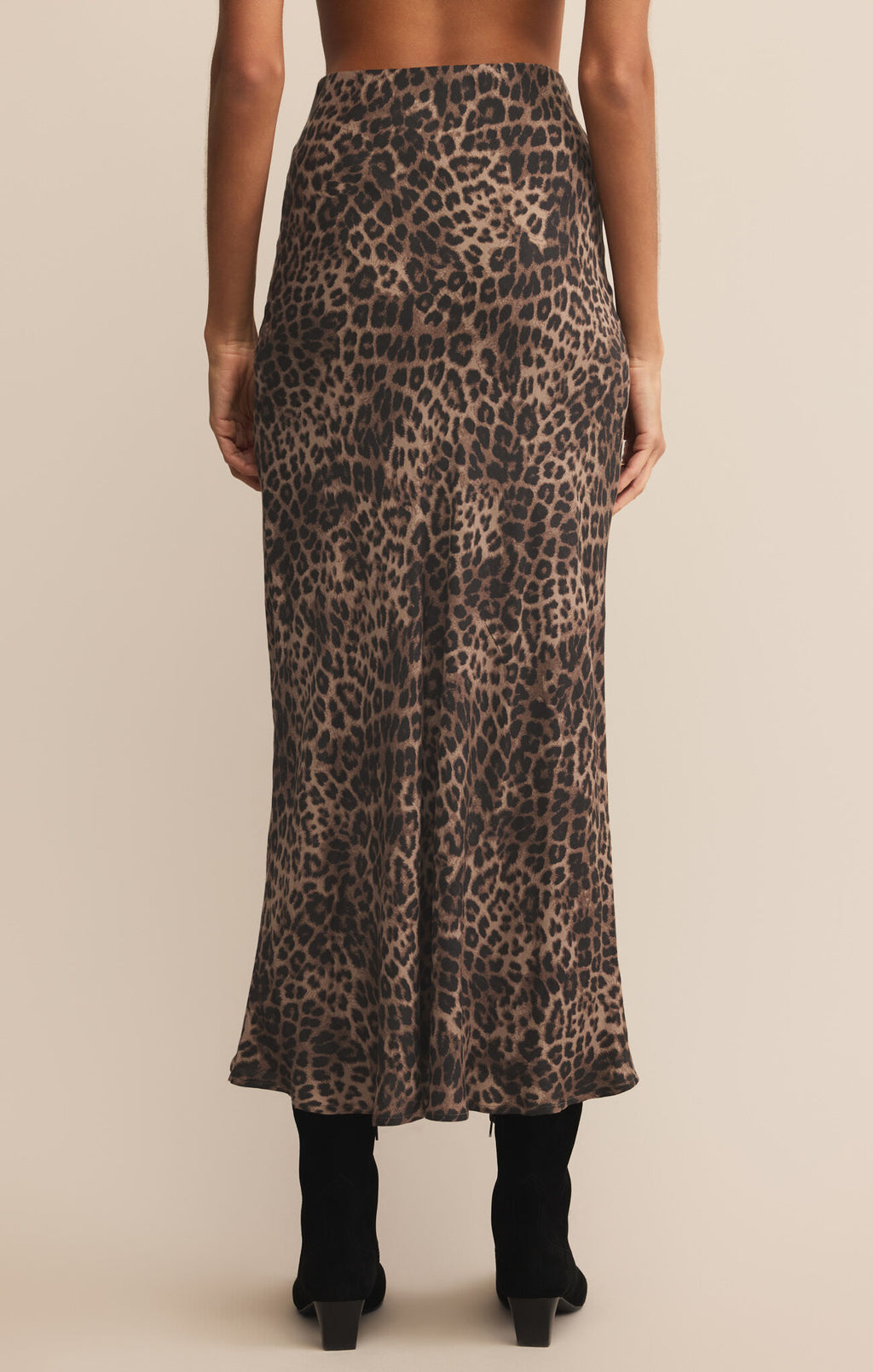 Woman wearing a graphic t-shirt and leopard print skirt on a beige 

Izabel Leopard Skirt