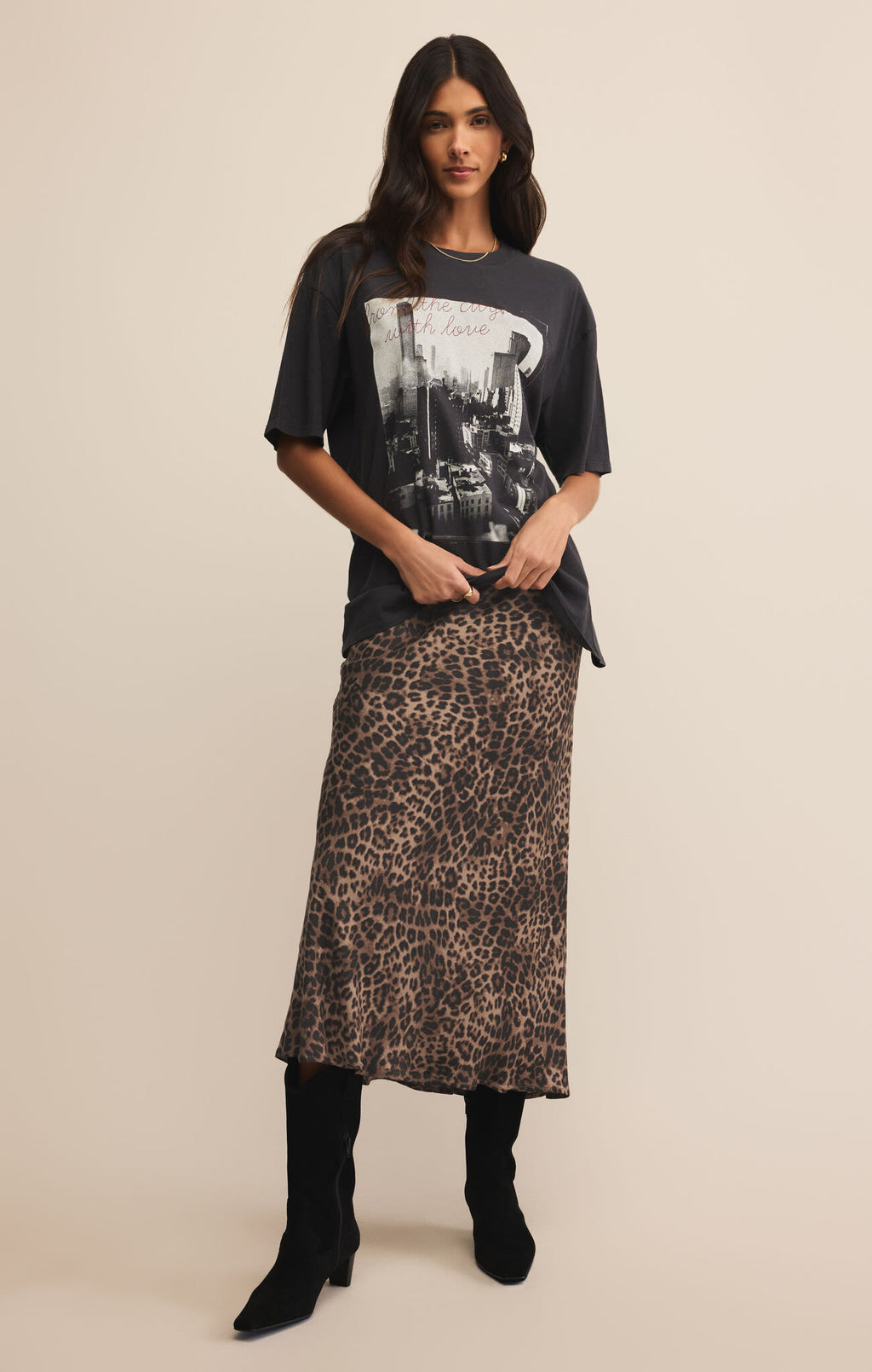 Woman wearing a graphic t-shirt and leopard print skirt on a beige 

Izabel Leopard Skirt