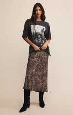 Woman wearing a graphic t-shirt and leopard print skirt on a beige 

Izabel Leopard Skirt