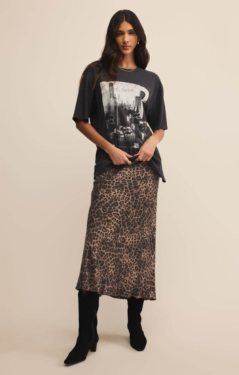 Woman wearing a graphic t-shirt and leopard print skirt on a beige 

Izabel Leopard Skirt