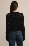 Person wearing a black knit cardigan with a beige background
Rosalyn Sweater