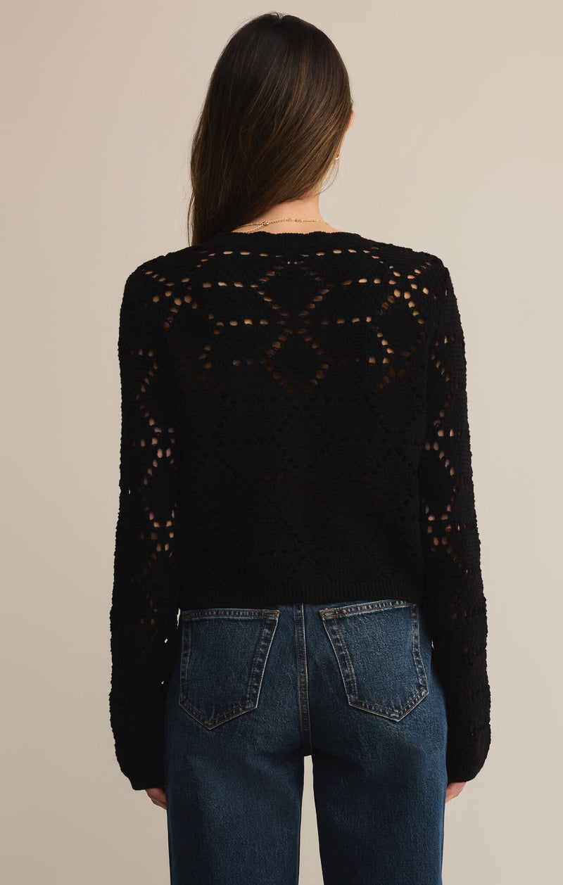 Person wearing a black knit cardigan with a beige background
Rosalyn Sweater