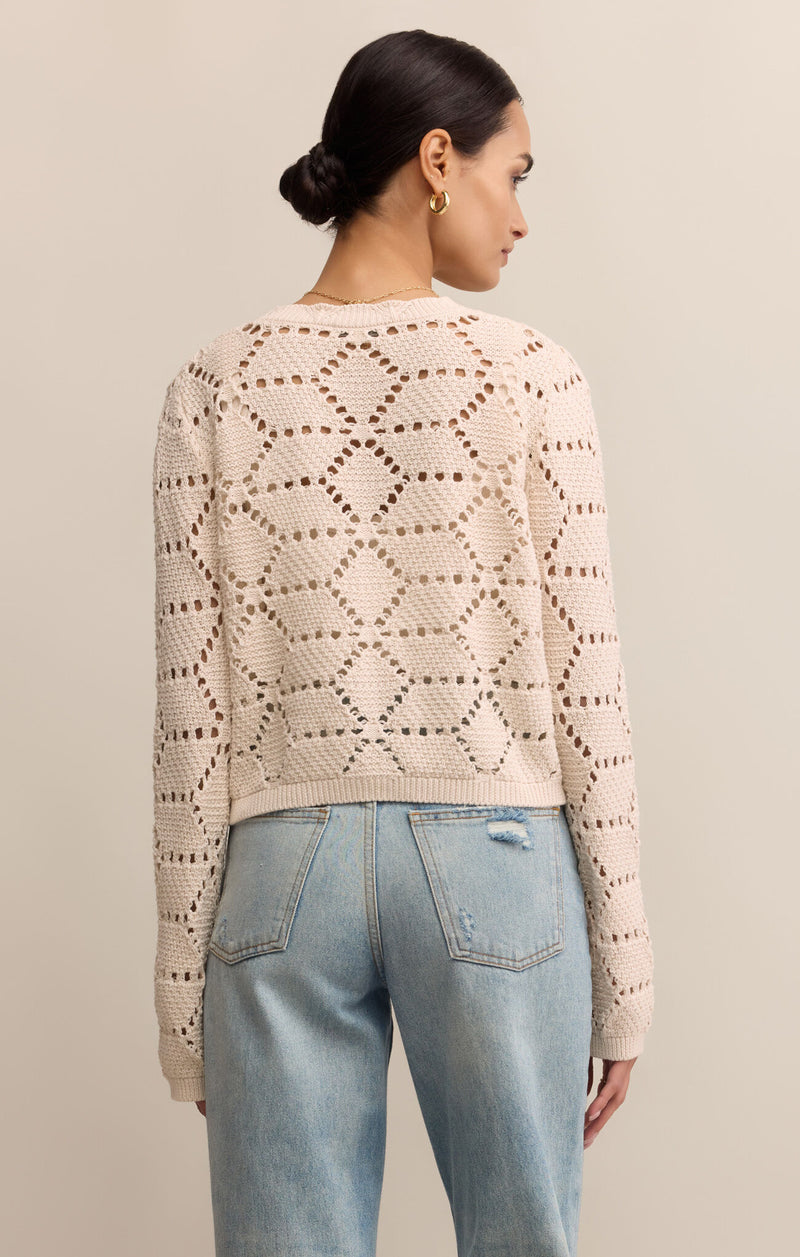 Woman wearing a beige patterned sweater and light blue jeans against a beige background
Rosalyn Cardigan Sweater