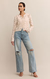 Woman wearing a white lace top and blue jeans on a beige background
Rosalyn Cardigan Sweater