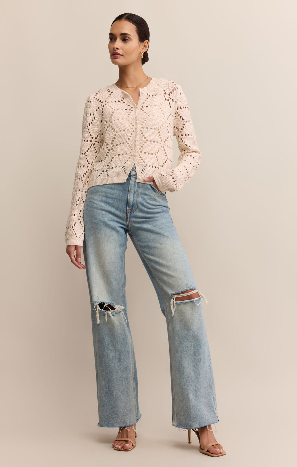Woman wearing a white lace top and blue jeans on a beige background
Rosalyn Cardigan Sweater